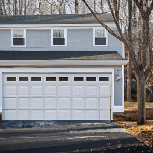 Exterior of a Natick suburban home showing a closed modern garage door and driveway in soft morning light.