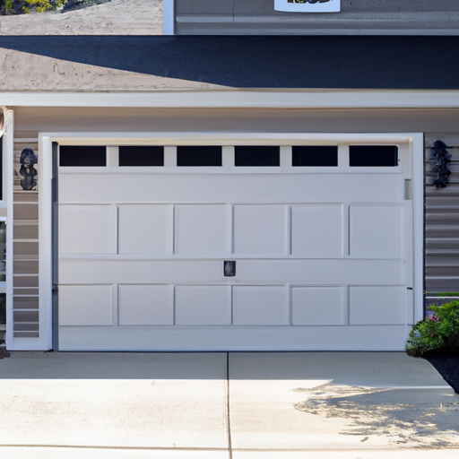Sectional garage door on a suburban Natick, MA home with clear driveway and landscaping visible.