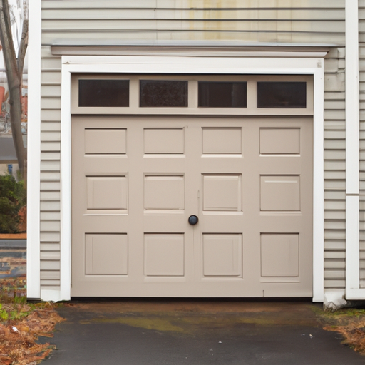Closed residential garage door on a New England colonial home in Natick, MA with light frost on the driveway.