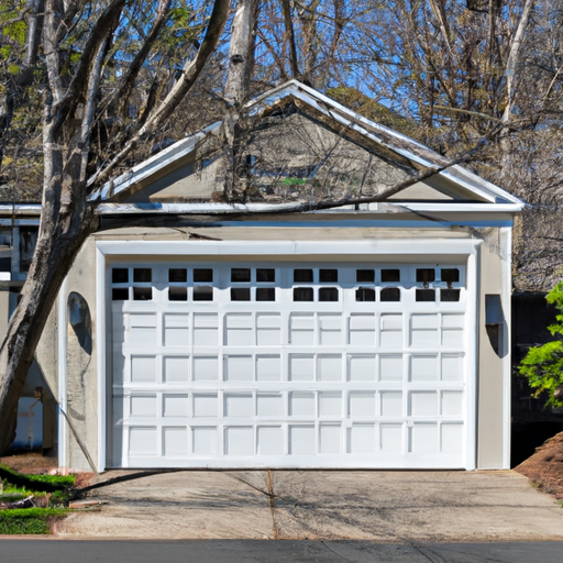 Editorial exterior of a suburban Natick garage with a closed sectional garage door and clear driveway.